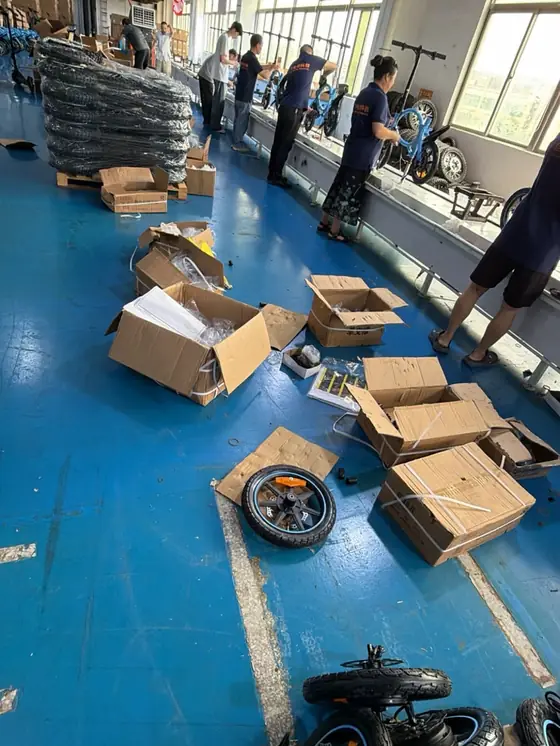 Entrepôt en préparation de commande, cartons ouverts et deux-roues