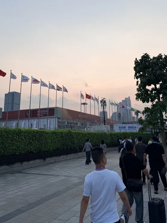 Visitors on the Pazhou complex forecourt under the Canton Fair flags