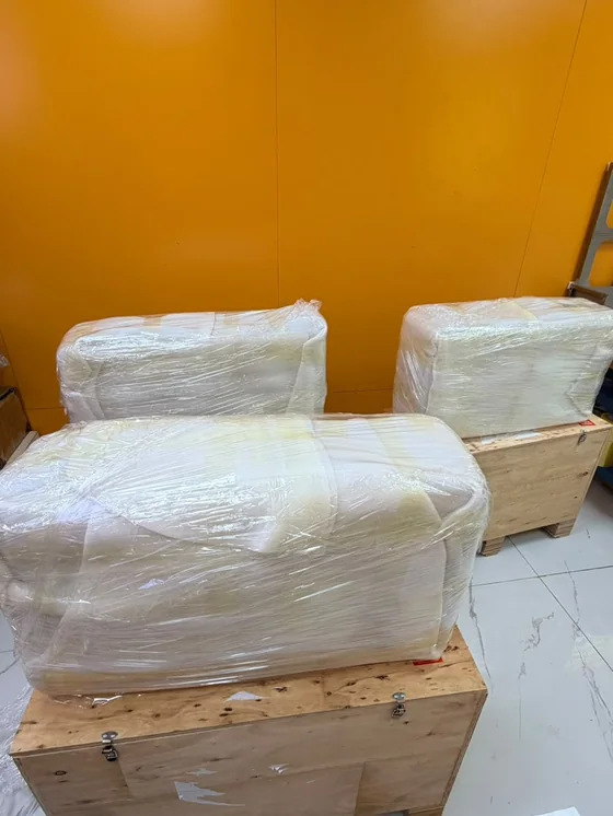 Goods wrapped and strapped onto wooden crates